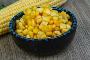 Sweet corn in a bowl on wooden background photo