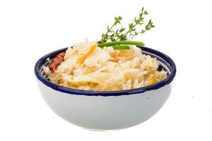 Fermented cabbage in a bowl on white background photo