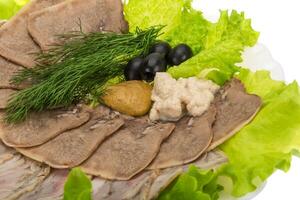 Pork tongue on the plate and white background photo