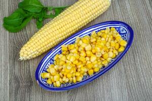 Sweet corn in a bowl on wooden background photo