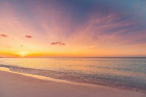 Closeup sea sand beach. Panoramic beach landscape. Inspire tropical beach seascape horizon. Orange and golden sunset sky calmness tranquil relaxing sunlight summer mood. Vacation travel holiday banner photo