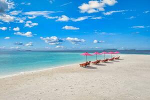 Amazing tranquil sea sand sky. Recreational summer travel tourism. Aerial landscape view with chairs and umbrellas on paradise island beach, seaside. Resort vacation, exotic nature. Beautiful tropics photo