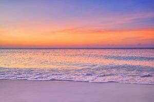 Closeup sea sand beach. Panoramic beach landscape. Inspire tropical beach seascape horizon. Orange and golden sunset sky calmness tranquil relaxing sunlight summer mood. Vacation travel holiday banner photo