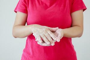 Woman washing hands with soap for COVID-19 corona virus prevention concept photo