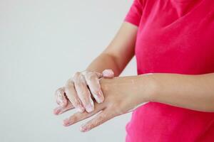 Woman washing hands with soap for COVID-19 corona virus prevention concept photo