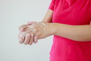 Woman washing hands with soap for COVID-19 corona virus prevention concept photo