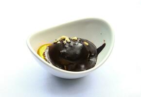 Profiterole in a bowl on white background photo