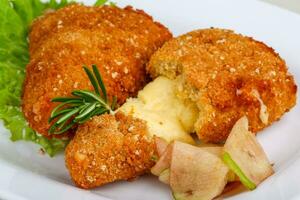 Fried cheese on the plate photo