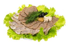 Pork tongue on the plate and white background photo