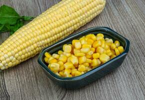 Sweet corn in a bowl on wooden background photo