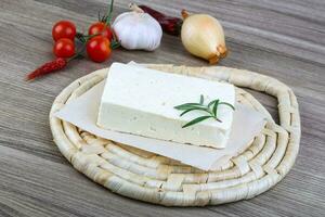Cheese Brinza on wooden board and wooden background photo