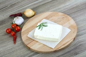 Cheese Brinza on wooden board and wooden background photo