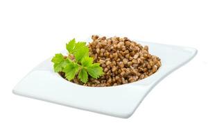 Buckwheat in a bowl on white background photo