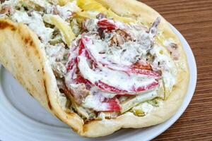 Souvlaki on the plate and wooden background photo