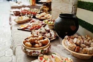 Buffet table of reception with cold snacks, meat and salads. photo