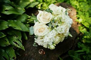 Beautiful tender wedding bouquet and rings. photo