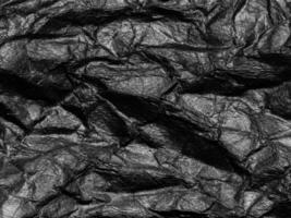 Black crumpled paper texture background. Copy space for design and artwork photo