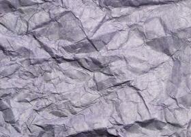 Abstract modern purple crumpled paper texture background. photo