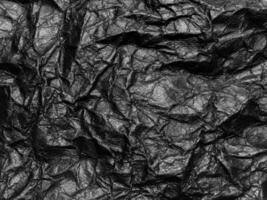 Black crumpled paper texture background. Copy space for design and artwork photo