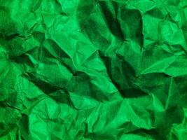 Closeup view of green crumpled paper texture background. photo