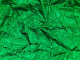 Closeup view of green crumpled paper texture background. photo