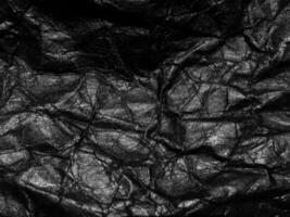 Black crumpled paper texture background. Copy space for design and artwork photo