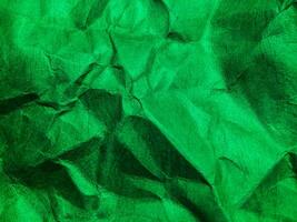 Closeup view of green crumpled paper texture background. photo