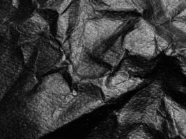 Black crumpled paper texture background. Copy space for design and artwork photo