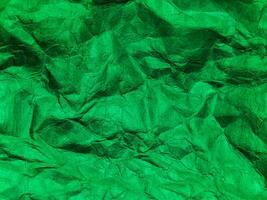 Closeup view of green crumpled paper texture background. photo