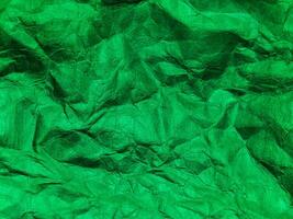 Closeup view of green crumpled paper texture background. photo