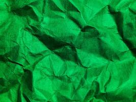 Closeup view of green crumpled paper texture background. photo