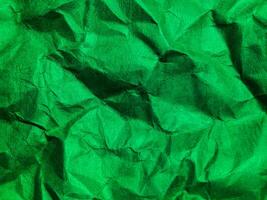 Closeup view of green crumpled paper texture background. photo