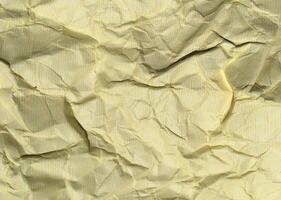 Yellow crumpled paper background with pattern for design photo