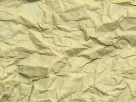 Yellow crumpled paper background with pattern for design photo