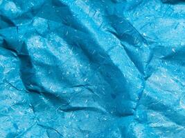 Texture of blue crumpled paper background for design photo