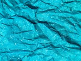 Texture of blue crumpled paper background for design photo