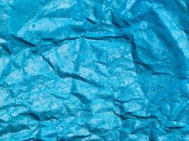 Texture of blue crumpled paper background for design photo