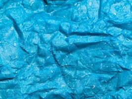 Texture of blue crumpled paper background for design photo