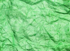 Pattern of green crumpled paper texture background. photo