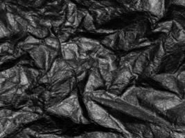 Black crumpled paper texture background. Copy space for design and artwork photo