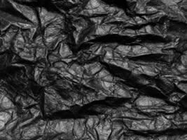 Black crumpled paper texture background. Copy space for design and artwork photo