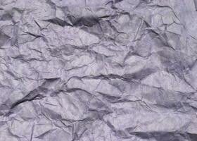 Abstract modern purple crumpled paper texture background. photo