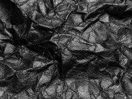 Black crumpled paper texture background. Copy space for design and artwork photo