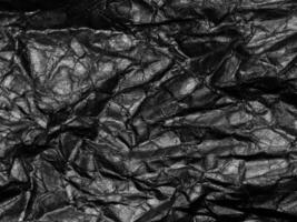 Black crumpled paper texture background. Copy space for design and artwork photo