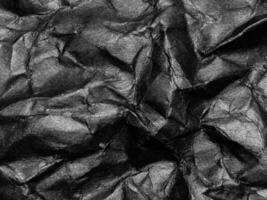 Black crumpled paper texture background. Copy space for design and artwork photo