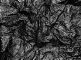Black crumpled paper texture background. Copy space for design and artwork photo