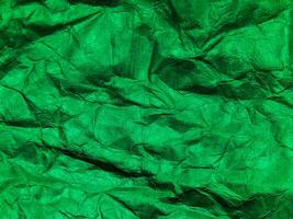 Closeup view of green crumpled paper texture background. photo