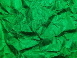 Closeup view of green crumpled paper texture background. photo
