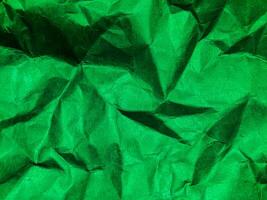 Closeup view of green crumpled paper texture background. photo