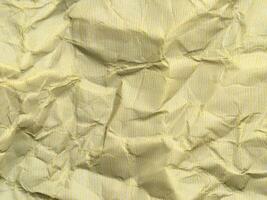 Yellow crumpled paper background with pattern for design photo